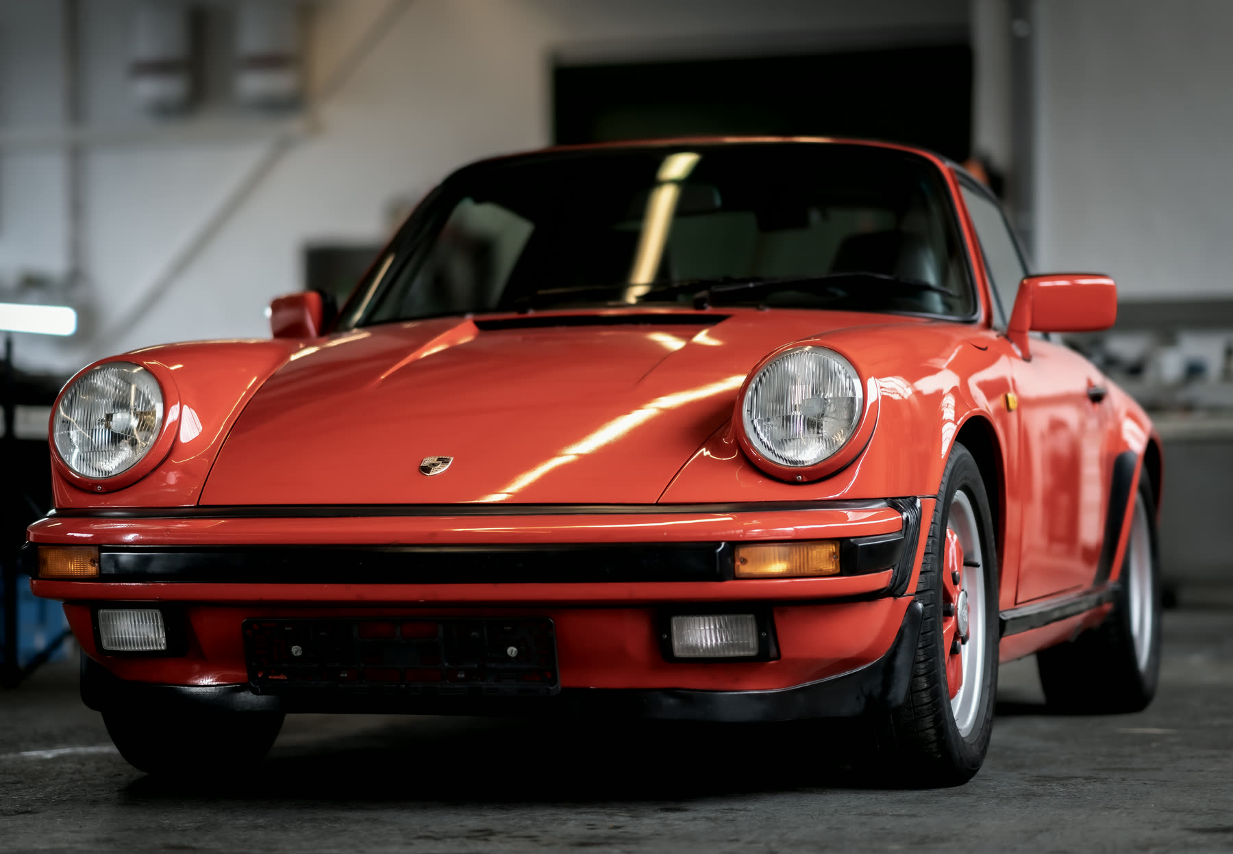 Roter Porsche 911 Turbo in der Werkstatthalle bei Abendlicht